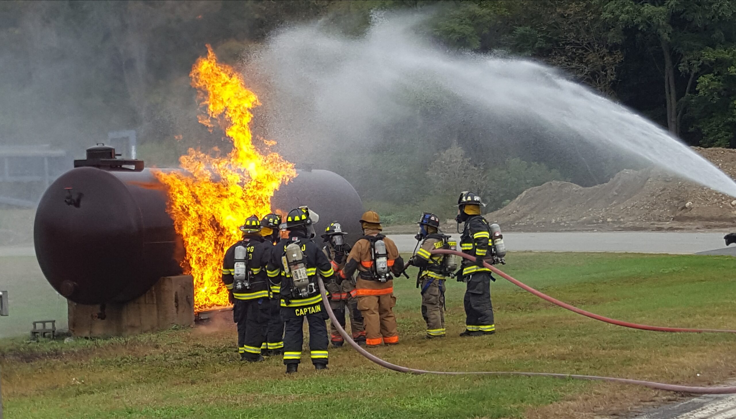 firefighters extinguishing a propane tank fire